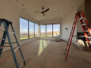 Unfurnished room with a ceiling fan and baseboards