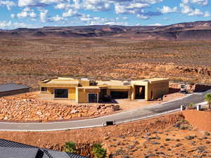 Aerial view of property and surrounding area featuring a mountain backdrop