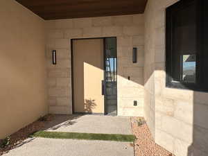 Entrance to property with concrete block siding