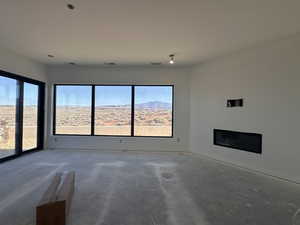 Unfurnished living room featuring unfinished concrete floors
