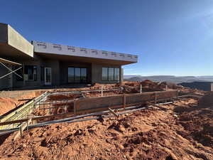 Rear view of house featuring stucco siding and a mountain view