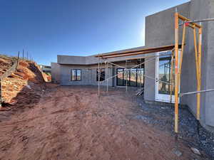 Rear view of property with a patio and stucco siding