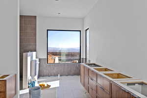 Kitchen featuring wood finish cabinetry and light tile patterned floors