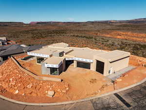View from above of property with a mountainous background and a desert landscape