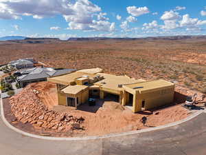 Aerial view of property and surrounding area with a mountainous background