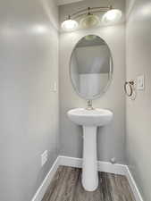 Bathroom with wood finished floors and baseboards