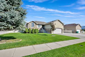Ranch-style house featuring stone siding, stucco siding, a garage, and concrete driveway