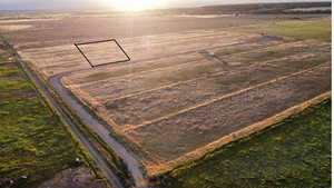 Overview of rural landscape featuring large plots for crops