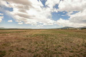View of yard featuring a rural view and a mountain view