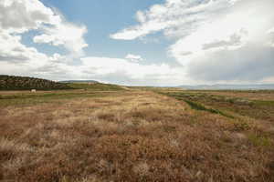 View of undeveloped land featuring rural landscape and mountains