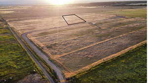 Aerial view of sparsely populated area featuring rows of crops and property boundaries highlighted