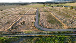 Aerial view of sparsely populated area featuring mountains and abundant farmland