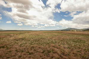View of undeveloped land with rural landscape and mountains