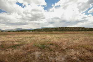 View of mountain backdrop featuring rural landscape