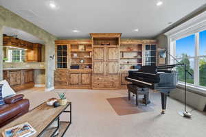 Living room with light colored carpet and recessed lighting