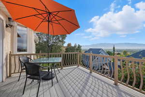 Trex type deck featuring a mountain view and outdoor dining space