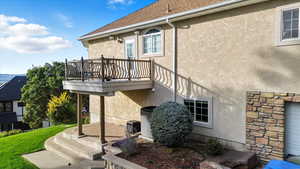 View of home's exterior with stone siding, stucco siding, and a yard