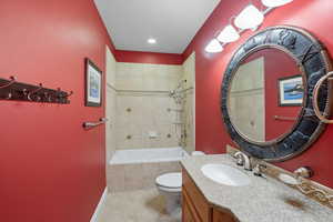 Bathroom with vanity, tiled shower / bath, and light tile patterned floors