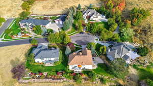Aerial view of property and surrounding area featuring nearby suburban area
