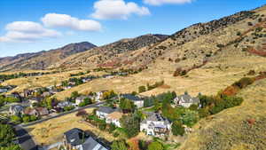 Aerial view of property's location featuring mountains and nearby suburban area