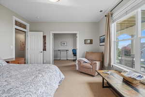 Bedroom with light colored carpet and baseboards