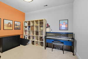 Living area featuring light carpet