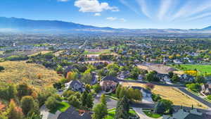 View of property location featuring mountains and nearby suburban area