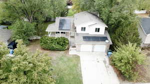 View from above of property featuring a tree filled landscape