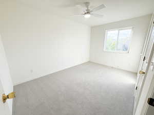 Unfurnished bedroom featuring carpet flooring and ceiling fan