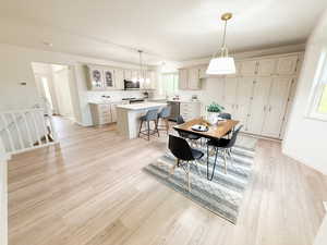 Dining area with baseboards and light wood-type flooring