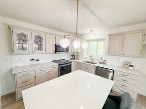 Kitchen featuring light wood-style flooring, stainless steel appliances, and backsplash