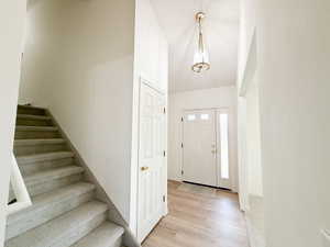 Foyer entrance with stairs and light wood finished floors
