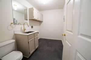 Bathroom featuring vanity and toilet