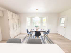 Dining room with light wood-style floors and baseboards