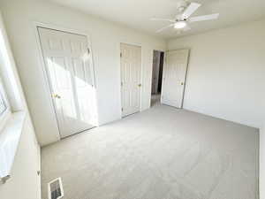Unfurnished bedroom with carpet and a ceiling fan
