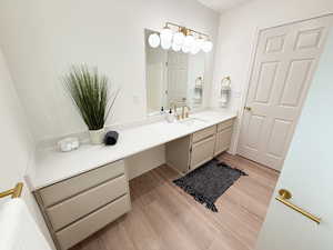 Bathroom with vanity and light wood finished floors