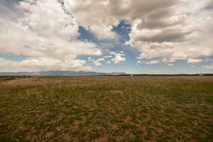 View of yard featuring a view of countryside and a mountain view