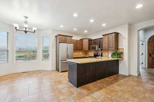 Kitchen  and dining area, stainless steel appliances, granite countertops, tile flooring, and 9' ceiling.