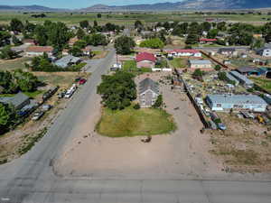 Aerial view of property and surrounding area featuring a mountain backdrop