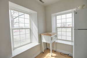 Dining area featuring light wood-style floors and baseboards