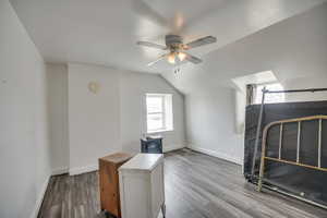 Bonus room with vaulted ceiling, wood finished floors, and a ceiling fan