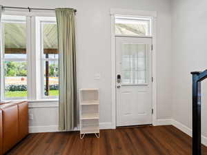 Doorway with wood finished floors and stairs