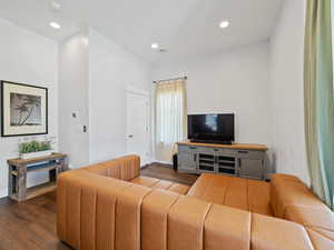 Living area with dark wood-style floors and recessed lighting