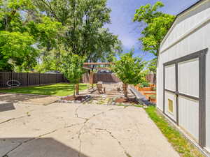 Fenced backyard with a patio and a pergola