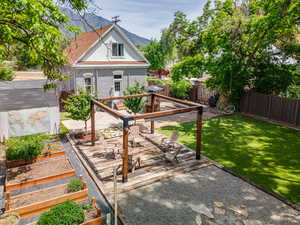 Fenced backyard featuring a patio area and a deck with mountain view