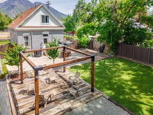 Deck with a fenced backyard and a mountain view