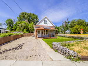 View of front of property with covered porch and driveway