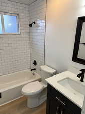 Full bathroom with vanity, bathing tub / shower combination, and wood finished floors