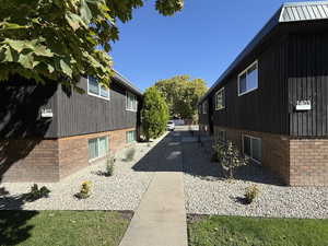 View of side of property with brick siding and a metal roof