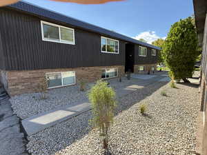 Back of property featuring brick siding